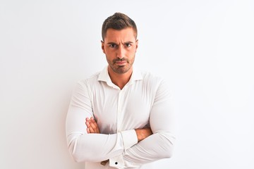 Fototapeta premium Young handsome business man wearing elegant shirt over isolated background skeptic and nervous, disapproving expression on face with crossed arms. Negative person.