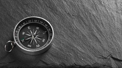 compass on a stone background. Top view with copy space © spaxiax