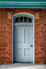 Fototapeta na wymiar Blue door on a brick building