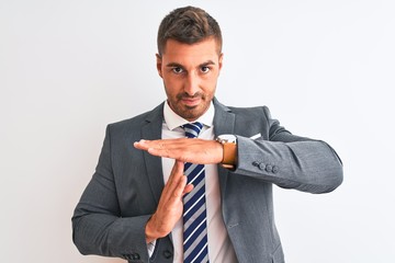 Young handsome business man wearing suit and tie over isolated background Doing time out gesture...