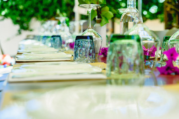 Modern upside down crystal glasses arranged on a banquet table.