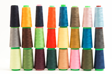 Colorful bobbin thread isolated on white background.