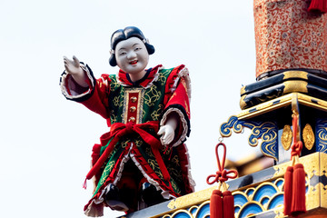 Fototapeta na wymiar Mechanical marionette on a ornate traditional wooden float during the Takayama Spring Festival. Japan