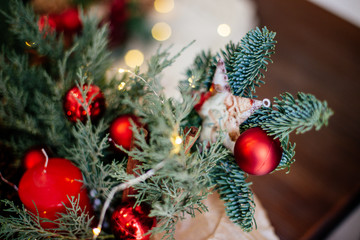 Red christmas wreath on table.