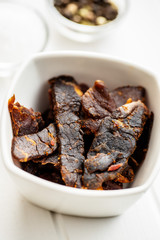 Beef jerky pieces. Dried beef meat.
