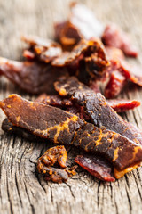 Beef jerky pieces. Dried beef meat.