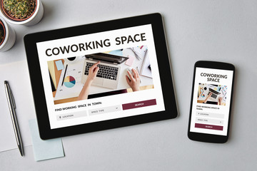 Coworking space concept on tablet and smartphone screen. Top view