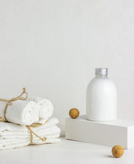 Obraz na płótnie Canvas Cosmetics and towels on a white background. Design. Minimal concept.