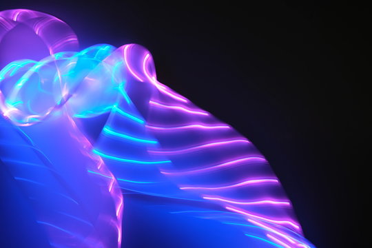 Abstract background of purple and blue neon lights in motion. Backdrop for your design.