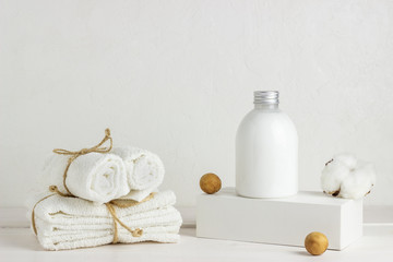 Fototapeta na wymiar Cosmetics and towels on a white background. Design. Minimal concept.