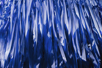 Strips of plastic form a blue trendy background.