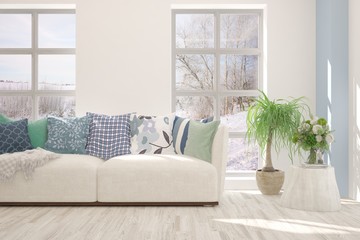 Stylish room in white color with sofa and winter landscape in window. Scandinavian interior design. 3D illustration