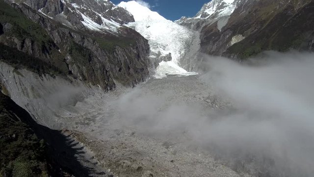 An aerial view of Mt. Gongga (Gonggashan, Minya Konka), the highest mountain of Sichuan, China (7 556 m), with its Glacier no. 1 in Hailougou valley and clouds slowly covering the glacier