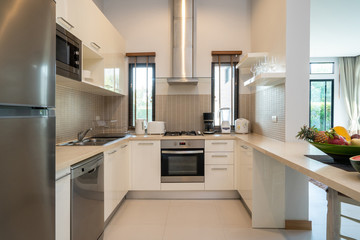 kitchen area which feature island counter and built in furniture