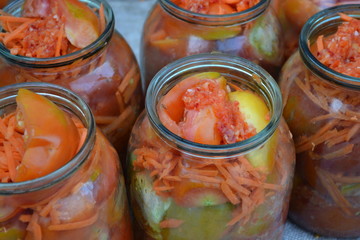 Homemade. Natural products. Preservation. Blanks for the winter. Marinated. Grated carrot, Red and yellow tomatoes in jars