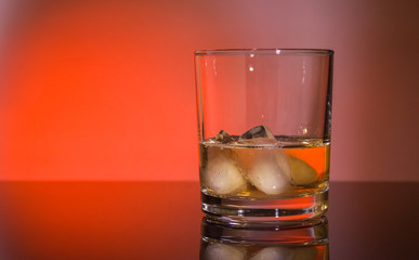 Glass whiskey glass with ice, free space for text