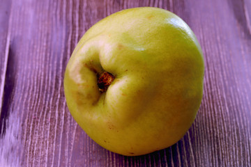 Natural quince on wooden background.