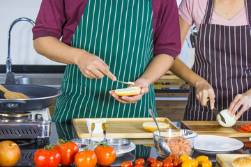 Young couple cooking breakfast together