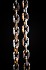 Rusty chains weathering.  Chain on black background.