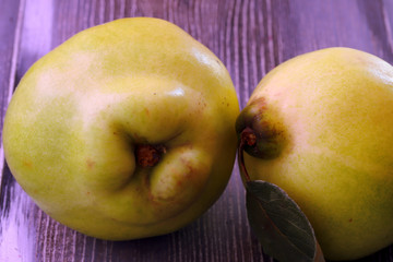 Natural quince on wooden background.
