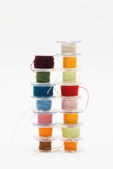 Colorful bobbin thread isolated on white background.
