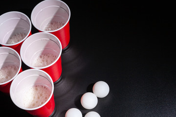 Beer pong college game on black background