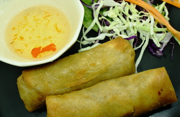 deep fried spring roll and sweet chili sauce on dish