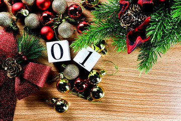01January  letters and red Christmas balls on a wooden calendar block on a wooden table.