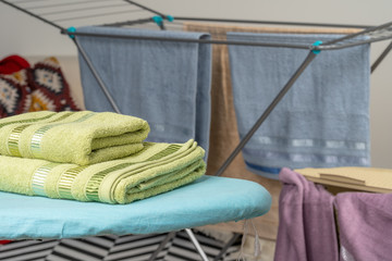 Housework concept. Ironing towels on ironing board