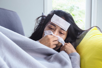 Asian women have high fever and runny nose. sick people concept