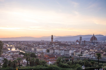 Fototapeta na wymiar View over Arno river, Florence Cathedral and Palazzo Vecchio tower at sunset. Piazzale Michelangelo, Florence, Italy.