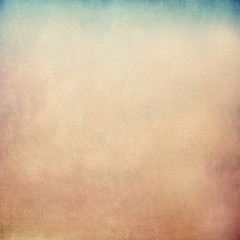 A smooth beige concrete wall with spots and small scratches on it