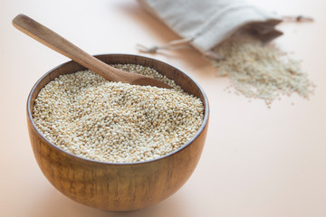 Raw quinoa close up in a wooden bowl