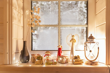 Beautiful burning candles and fairy lights on windowsill indoors