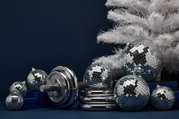 Dumbbell and Christmas ornaments. Fitness New Year and Christmas background