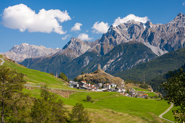 Ardez, a typical eastern Swiss village with Alps and Steinsberg castle in the background.