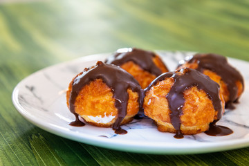 Profiterole with vanilla and chocolate sauce