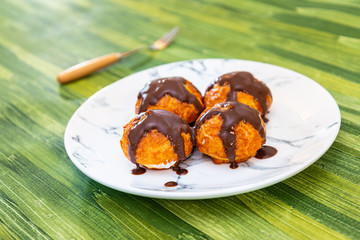 Profiterole with vanilla and chocolate sauce