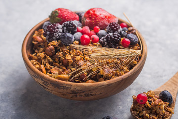 Morning  Granola, Fruits, Berries in bowl on grey concrete background. Healthy breakfast cereals. Concept of dieting, healthy  clean eating
