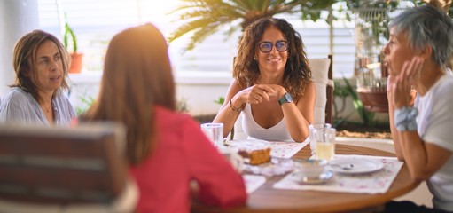 Young beautiful girl smiling happy and confident sitting dinking cup of coffee at terrace