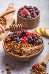 Morning  Granola, Fruits, Berries in bowl on grey concrete background. Healthy breakfast cereals. Concept of dieting, healthy  clean eating