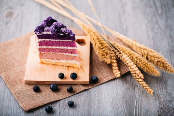 Close up slices of blueberry layer cakes on a wood tray. Dessert for holiday concept.