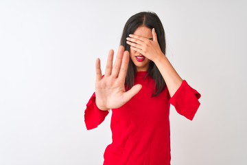 Young beautiful chinese woman wearing red dress standing over isolated white background covering eyes with hands and doing stop gesture with sad and fear expression. Embarrassed and negative concept.