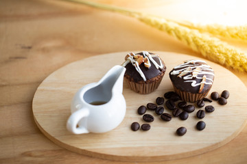 Tea Time with Chocolate cup cakes on wooden background.
