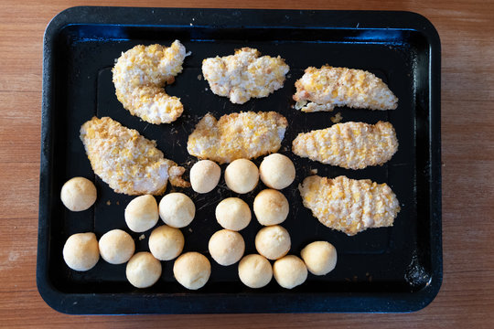 Frozen Breaded Chicken And Fried Small Potato Balls Before Cooking