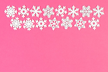 Top view of winter ornament made of white snowflakes on colorful background. Happy New Year concept with copy space