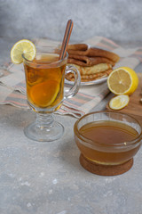 Rustic tea with lemon and cottage cheese on a gray stone background , vertical arrangement