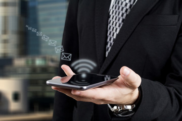 Businessman Sending Mail via Smartphone. Digital Wireless Technology and Networking
