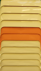 Plastic chairs in a tightly folded bundle. Close-up side view.