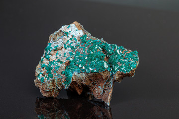 macro mineral stone Dioptase on a gray background